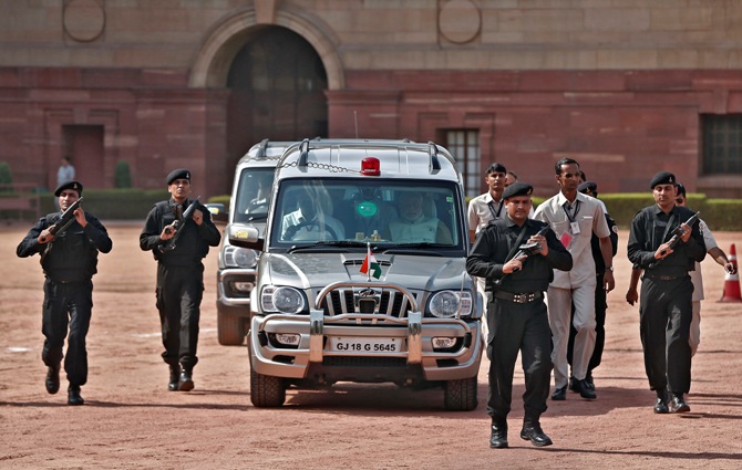 Prime Minister Narendra Modi (front R, in car), arrives to speak with the media after his meeting with President Pranab Mukherjee at the Rashtrapati Bhavan in New Delhi.