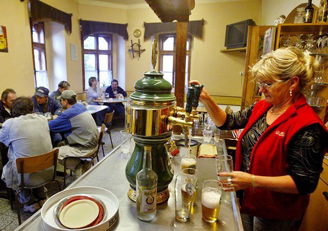 A woman serves beers in a bar in the Czech town of Horni Benesov.