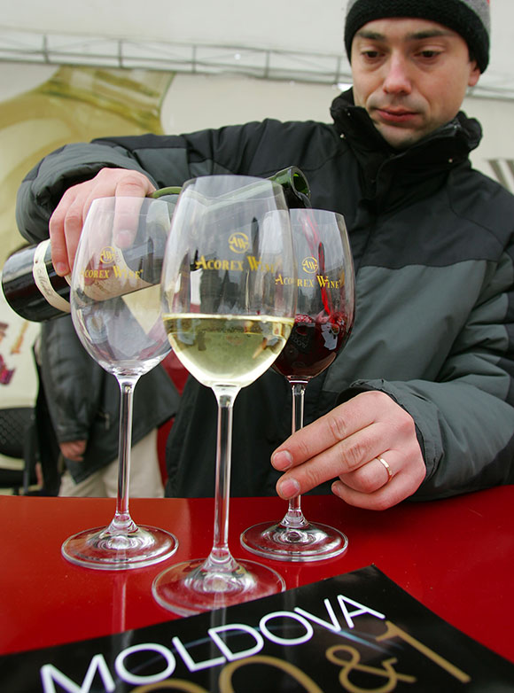 A Moldovan prepares wine glasses for tasting in central Bucharest.