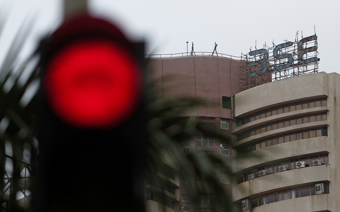 The Bombay Stock Exchange building is pictured next to a traffic signal in Mumbai.