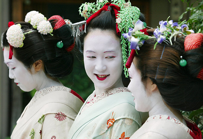 Japanese tourists Naomi Sato (L), Hitomi Abe (C) and Kumi Tamizane wear rented Maiko costumes in the ancient Japanese capital of Kyoto.