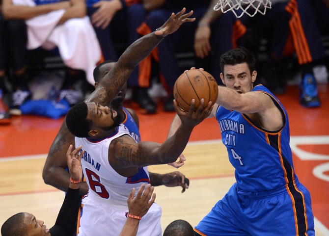 klahoma City Thunder forward Nick Collison (4) and Los Angeles Clippers center DeAndre Jordan (6) go for a rebound in the fourth quarter of game four of the second round of the 2014 NBA Playoffs at Staples Center. Clippers won 101-99.