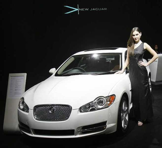A model poses with a Jaguar XF in New Delhi.
