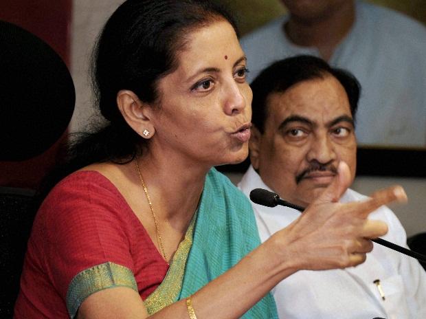 Nirmala Sitharaman, Union Minister of State Commerce & Industry, adresses the media along with BJP leader Eknath Khadase (R) at party office in Mumbai