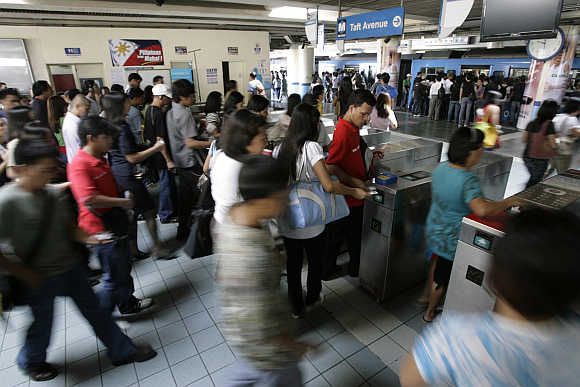 Commuters rush to board a train in Manila, the Philippines.