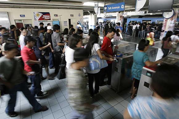 Commuters rush to board a train in Manila, the Philippines.