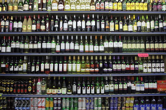 Alcohol lines shelves in a liquor store.
