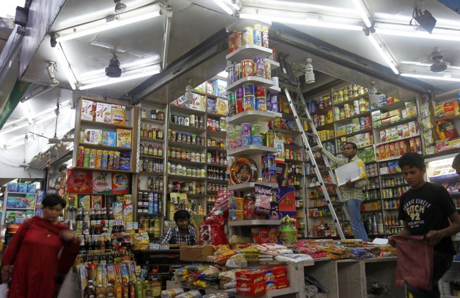Customers shop FMCG products in a family-owned store at a market in New Delhi.