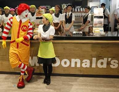 Image: McDonald's 'Ronald McDonald' character chats with a counter staff in Tokyo, Japan. Photographs: Kim Kyung-Hoon/Reuters