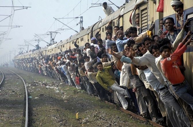 Passengers travel in an overcrowded train in Patna.