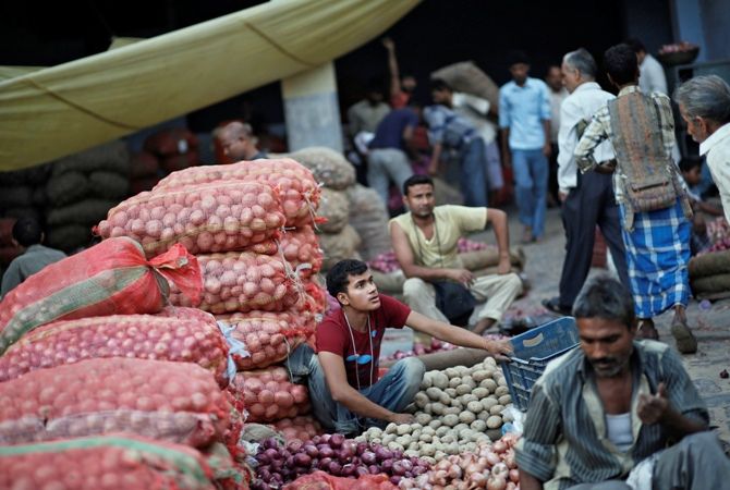Vendors wait for customers at a wholesale vegetable market in the old quarters of Delhi 