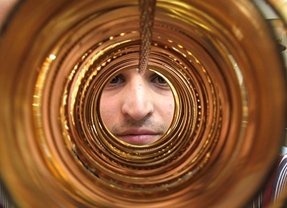 A goldsmith poses with gold bangles in his jewellery shop.