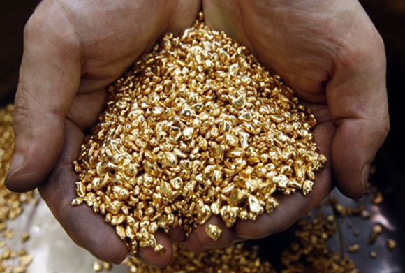 A worker scoops gold shots at Japanese jewellery brand, Ginza Tanaka's original equipment manufacturer (OEM) factory in the Chiba prefecture, east of Tokyo.