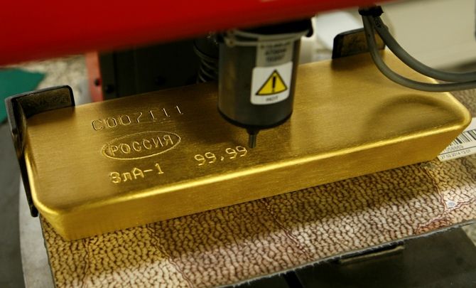 A machine engraves information on an ingot 99.99 percent pure gold at the Krastsvetmet non-ferrous metals plant in Russia's Siberian city of Krasnoyarsk.