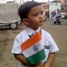 A boy holds a national flag