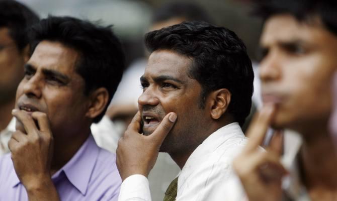 People look at a large screen displaying India's benchmark share index, on the facade of the Bombay Stock Exchange building in Mumbai. Photograph: Arko Datta/Reuters