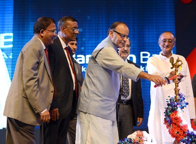 Arun Jaitley lights the ceremonial lamp as RBI Deputy Governor H R Khan (extreme left), Chandra Shekhar Ghosh (middle) and West Bengal Finance Minister Amit Mitra (right) look on.
