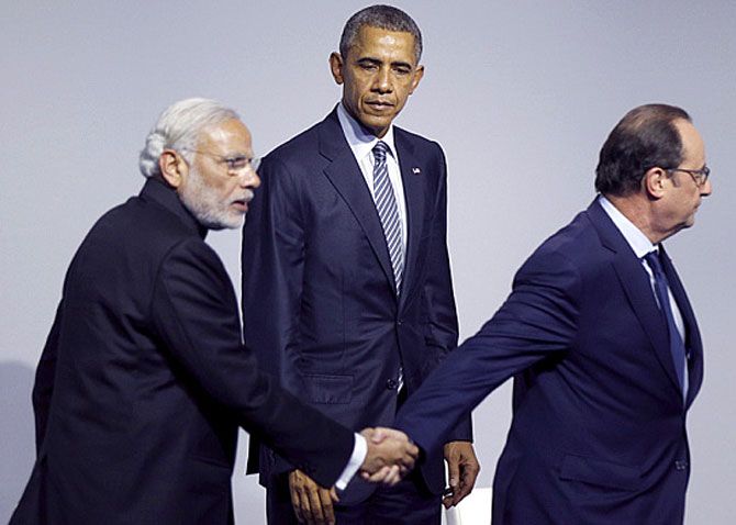 President Barack Obama looks on as Indian Prime Minister Narendra Modi and French President Francois Hollande depart the stage  Photo: Kevin Lamarque/Reuters