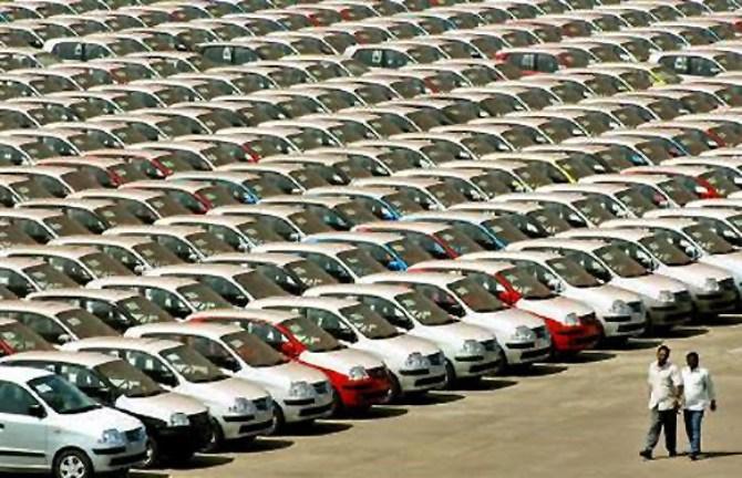 Image: Cars are inspected at the end of the production line. Photographs: Reuters