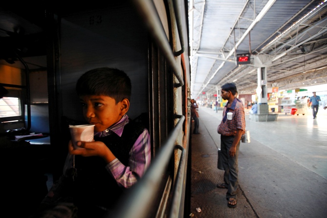 A boy drinks tea in the early morning inside a train at Agra Cantt Railway Station in Agra. Navesh Chitrakar/Reuters