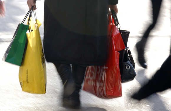 A woman carries shopping bags