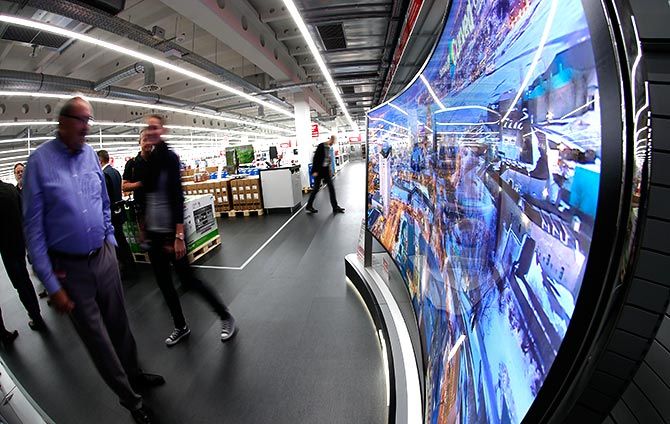 People watch a curved LED television
