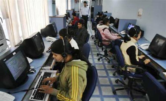 Employees at a call centre provide service support to customers in Siliguri. 