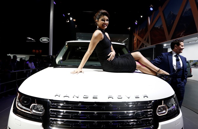 Actress Priyanka Chopra poses with Jaguar Land Rover's Range Rover LWB during its launch.