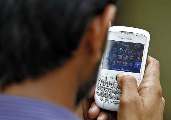 A man checks his mobile phone in New Delhi.