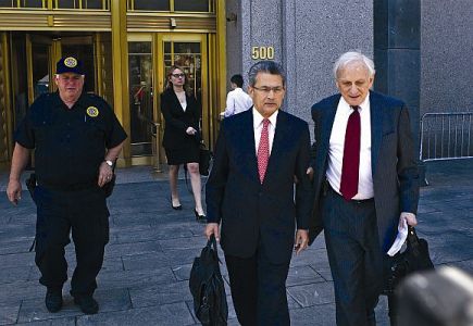 Rajat Gupta (2nd R) leaves Manhattan Federal Court with his lawyer, Gary Naftalis (R).