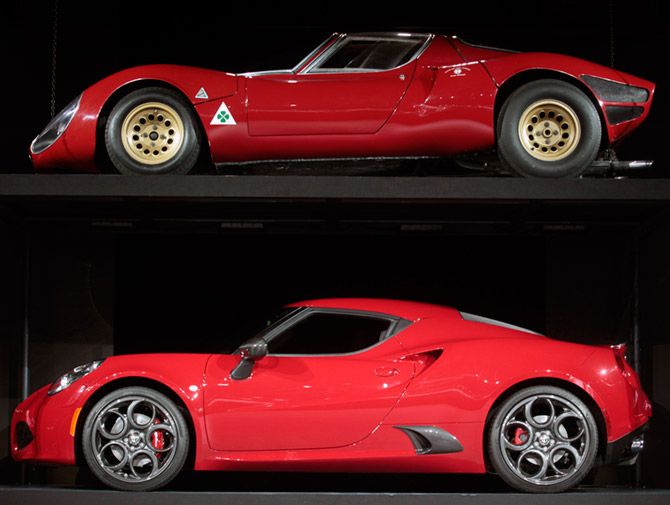 A 2015 Alfa Romeo 4C (bottom) is displayed along with a 1967 Alfa Romeo 33 Stradale (top) during the first press preview day of the North American International Auto Show in Detroit.