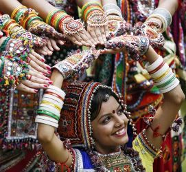 A girl dressed in traditional attire poses as she takes part in rehearsals for the garba dance ahead of Navratri festival in Ahmedabad.