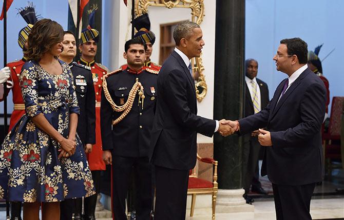 US First Lady Michelle Obama looks on as US President Barack Obama shakes hands with Tata group Chairman Cyrus Pallonji Mistry. Photograph: Vijay Verma/PTI