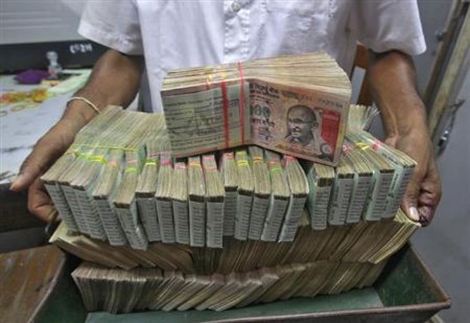 A man carries bank notes to the teller