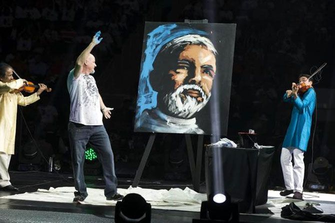 A painter reacts as he creates a portrait of Prime Minister Narendra Modi before he was scheduled to speak at Madison Square Garden in New York, during his visit to the United States.