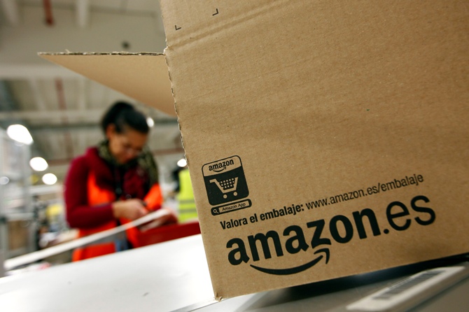 Image: A worker packs a box at Amazon's logistics centre in Graben near Augsburg. Photograph: Michaela Rehle/Reuters