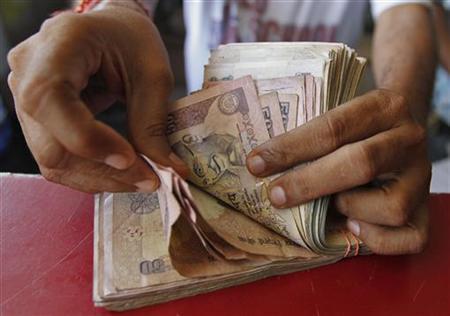 A man counting rupee notes.