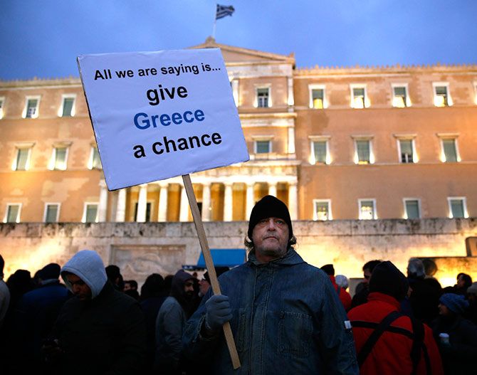 Image: A man takes part in a anti-austerity pro-government demo in front of the parliament in Athens February 11, 2015. 