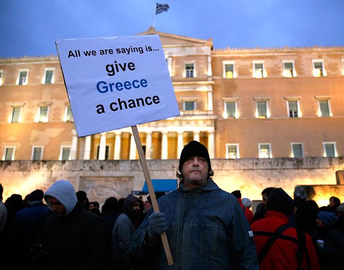 Image: A man takes part in a anti-austerity pro-government demo in front of the parliament in Athens February 11, 2015. 