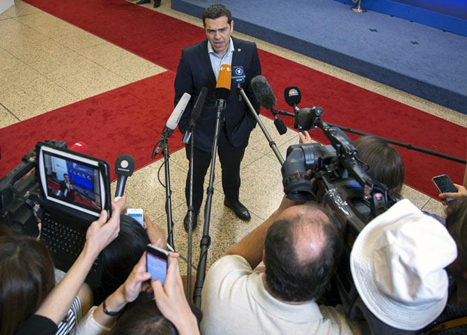 Image: Greek Prime Minister Alexis Tsipras holds a statement while leaving the European Council headquarters on the first day of an EU-CELAC Latin America summit in Brussels, Belgium June 11, 2015.