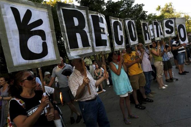 People hold letters that make up the sentence 'Zero cuts', during a demonstration in support of Greece in central Madrid, Spain.