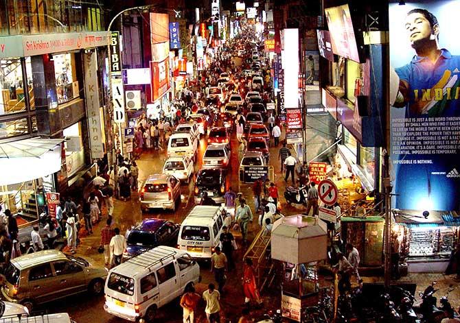 Commuters are seen on a busy commercial street in the southern Indian city of Bengaluru