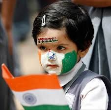 A schoolgirl, with her face painted in colours of the Indian national flag, holds a flag. 