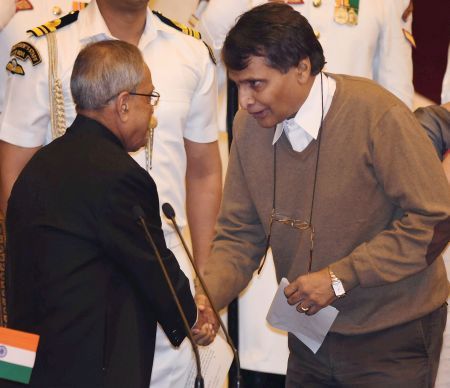 Image: President Pranab Mukherjee shakes hands with the new Cabinet minister Suresh Prabhu after administering him oath of office. Photograph: PTI photo