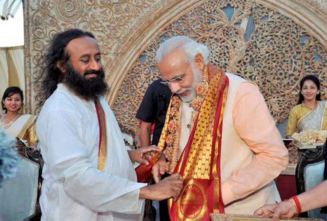 Prime Minister Narendra Damodardas Modi greeted by Art of Living founder Sri Sri Ravishankar on the opening day of the World Culture Festival on the banks of the Yamuna in New Delhi. Photograph: PTI