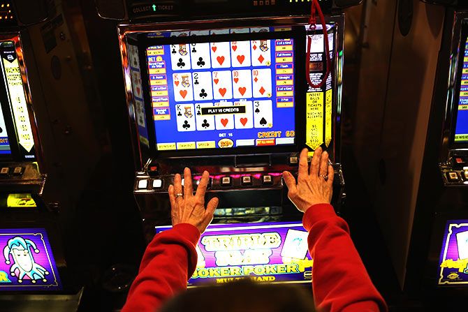 A patron plays the slots at the Trump Taj Mahal casino hotel on March 30, 2016 in Atlantic City, New Jersey
