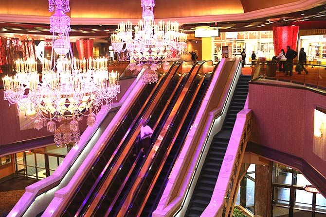 A patron rides the escalator at the Trump Taj Mahal casino hotel on March 30, 2016 in Atlantic City, New Jersey. 