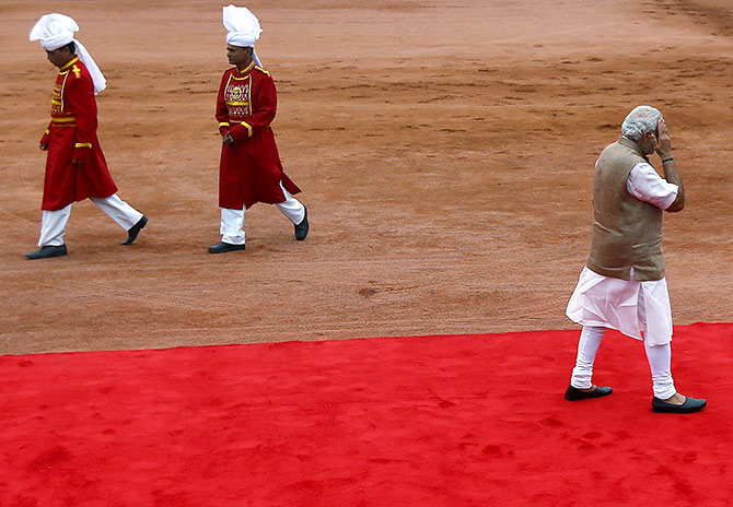 India's Prime Minister Narendra Modi (R) gestures as he leaves after a ceremonial reception