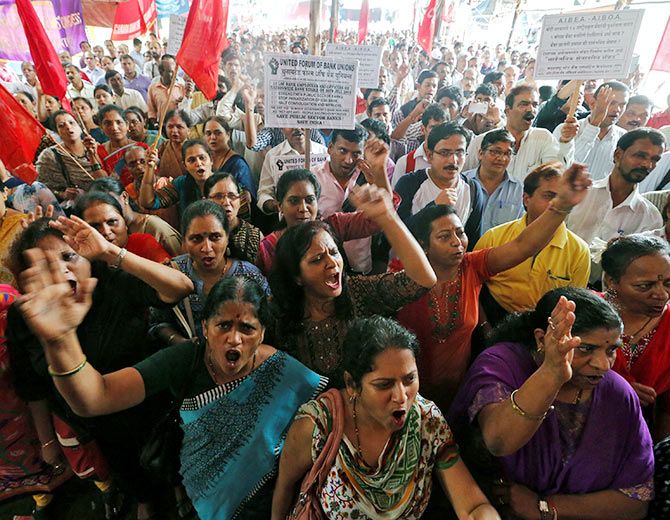 IMAGE: Bank employees shout slogans as they attend a strike opposing the government's proposal to merge State Bank of India's associate banks with SBI, and against the government's proposed move to privatise IDBI Bank.