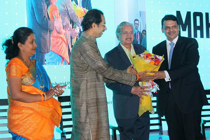 Maharashtra Chief Minister Devendra Fadnavis and Shiv Sena President Uddhav Thackeray congratulate state Industries Minister Subhash Desai for successfully wrapping up Rs 6.11 lakh crore investment proposals in the first two days of the Make in India Week as Mumbai mayor Snehal Ambekar looks on